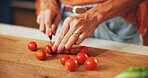 Cooking, woman and hands cut tomatoes in kitchen for dinner salad, organic recipe and vegetarian food. Wood board, person and vegetable ingredients for meal preparation, lunch cuisine and nutrition