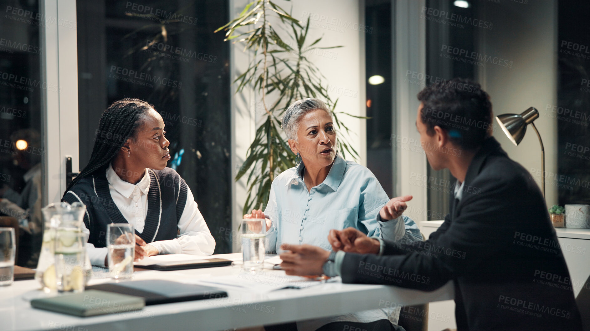 Buy stock photo Discussion, night and business people in meeting for financial review, budget report and feedback. Corporate team, professional and workers with documents for collaboration, strategy and planning