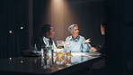 Documents, teamwork and business people at night meeting for overtime, planning or research. Creative startup, collaboration and man and woman working on project, proposal and brainstorming in office
