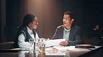 Feedback, paperwork and business people at night meeting for overtime, planning or research. Creative startup, collaboration and man and woman working on project, proposal and brainstorming in office