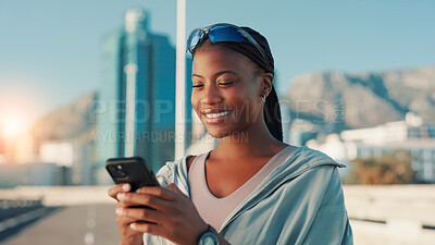 Buy stock photo Happy, black woman and fitness with phone in city for workout app, communication or performance. Active, female person or user with smile on mobile smartphone for exercise routine or schedule in town