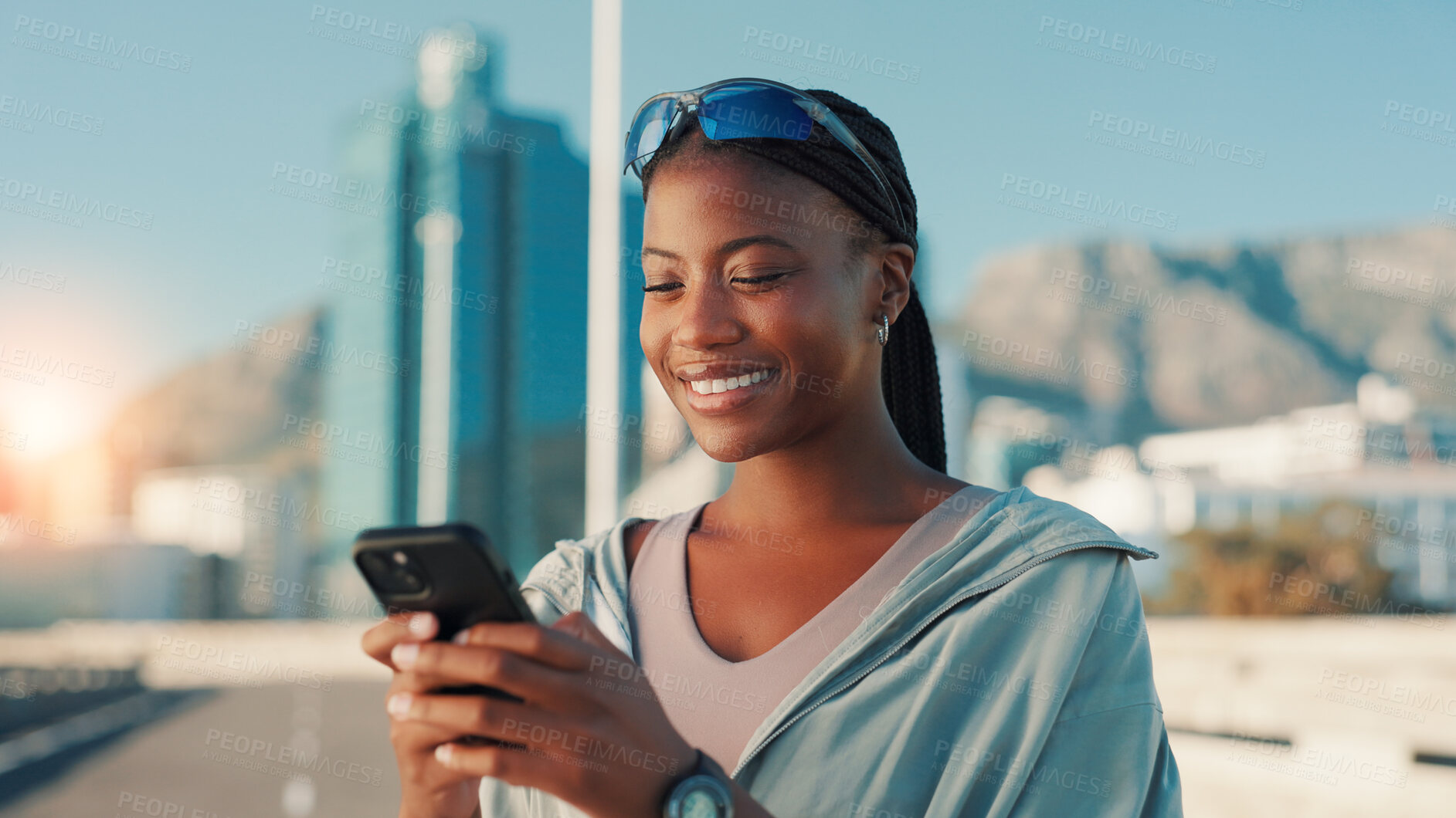 Buy stock photo Happy, black woman and fitness with phone in city for workout app, communication or performance. Active, female person or user with smile on mobile smartphone for exercise routine or schedule in town