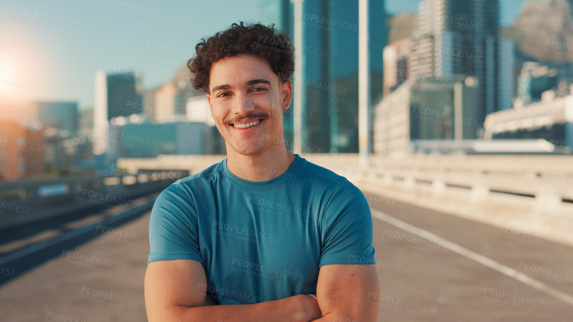 Buy stock photo Arms crossed, exercise and portrait of man on bridge in city for cardio workout or marathon training. Fitness, smile and sports with happy athlete or runner outdoor in urban town for challenge