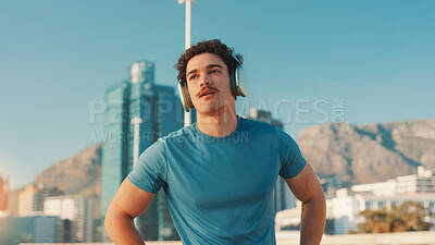 Buy stock photo City, music and thinking with runner man outdoor for break from cardio or fitness routine. Exercise, fatigue and headphones with exhausted athlete in urban town for running, sports or workout