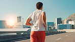 Back, man and running in city street for fitness workout, cardio exercise or outdoor training. Active, male person or runner with lens flare on road for physical activity, health or wellness in town