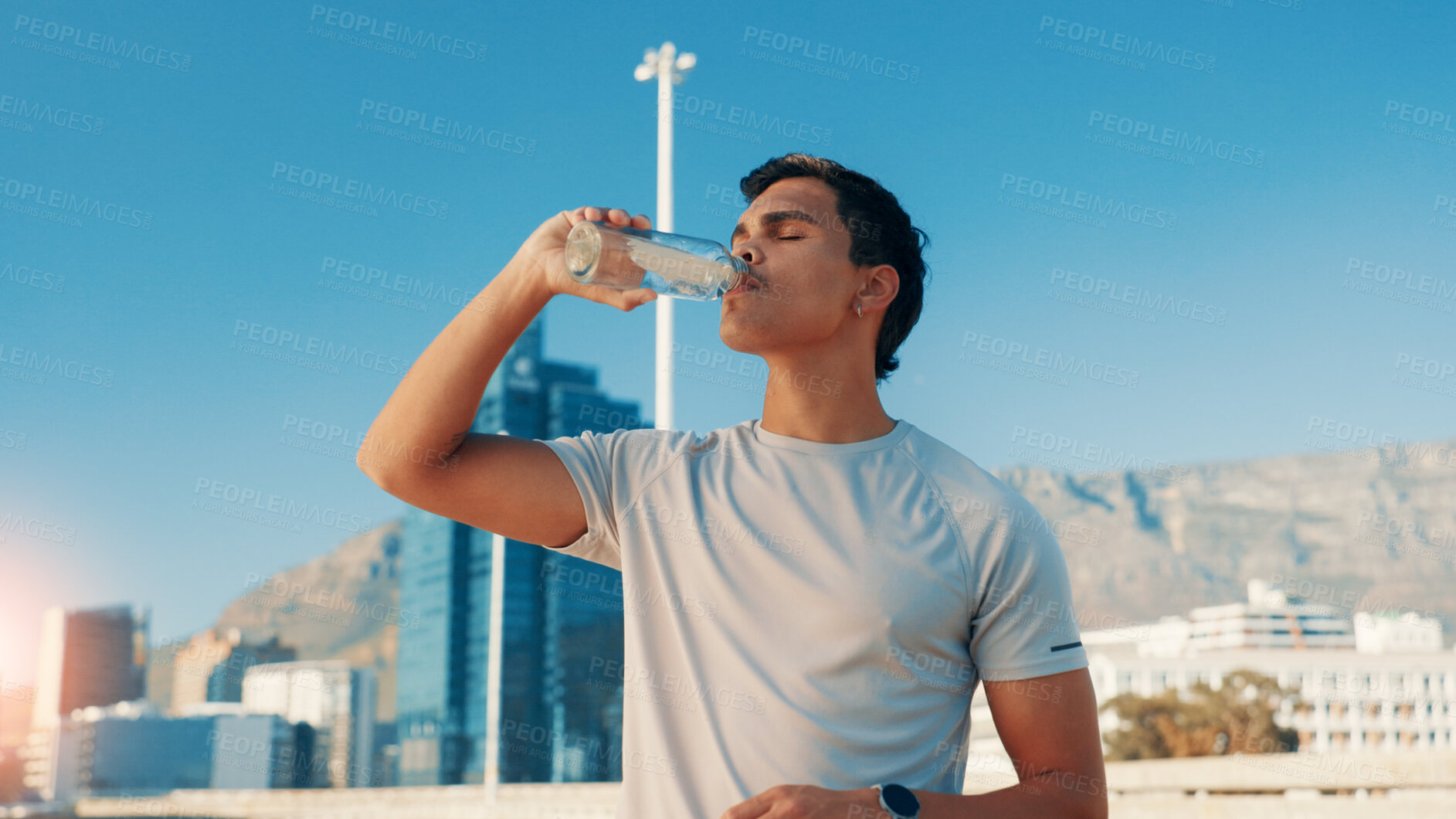 Buy stock photo Man, fitness and drinking water in city for break, natural sustainability or refreshment. Active, male person or thirsty runner with mineral liquid, aqua or beverage for hydration, recovery or rest