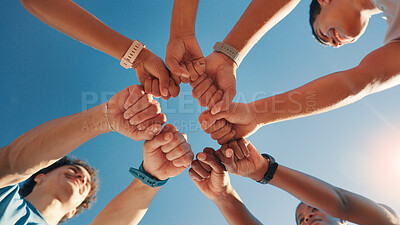 Buy stock photo People, team and fist bump in fitness with blue sky below for motivation, unity or mission. Low angle, group or friends with hands together in huddle, circle or solidarity for health and wellness