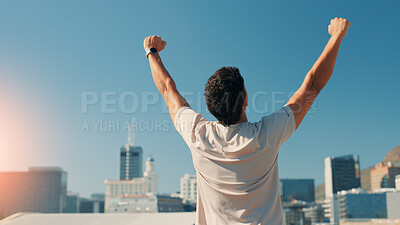 Buy stock photo Man, back and fitness with fist pump in city for conquer, achievement or workout success. Active, male person or runner with relief for exercise goals, accomplishment or winning in an urban town