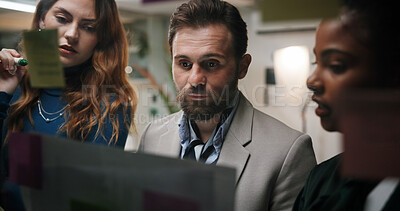 Buy stock photo Brainstorming, team and writing of ideas, serious and colleagues with marketing strategy at night. Dark, discussion and working late for collaboration in office, people and brand strategist with plan