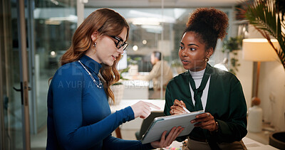 Buy stock photo Business women, night and discussion with tablet for design, project or schedule at office. Female people, employees or colleagues working late with technology for tasks, ideas or agenda at workplace
