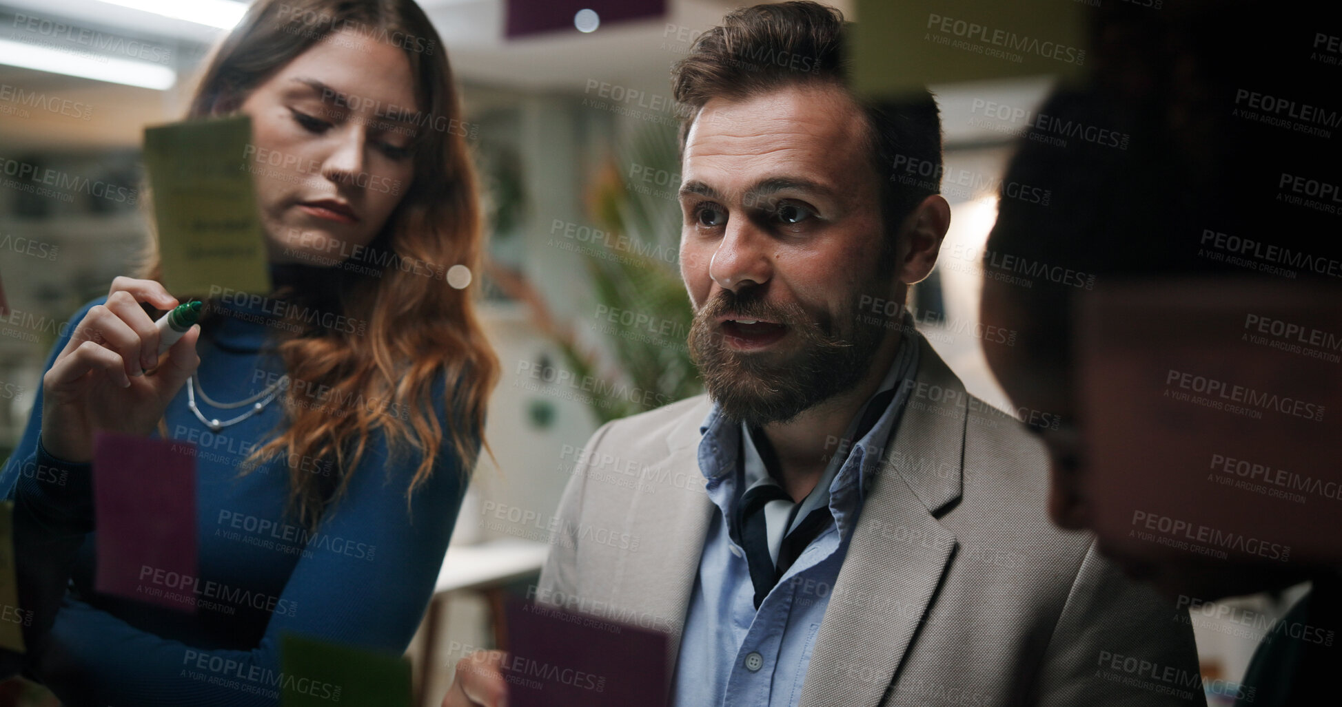 Buy stock photo Glass, group and planning for ideas, office and colleagues with marketing strategy, meeting and night. Working late, people and brainstorming with sticky notes for collaboration and brand strategist