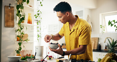 Buy stock photo Berries, bowl and cooking with man in kitchen of home for hobby, meal prep or nutrition. Breakfast recipe, fruit and ingredients with person in apartment for diet, health or vitamins as culinary chef