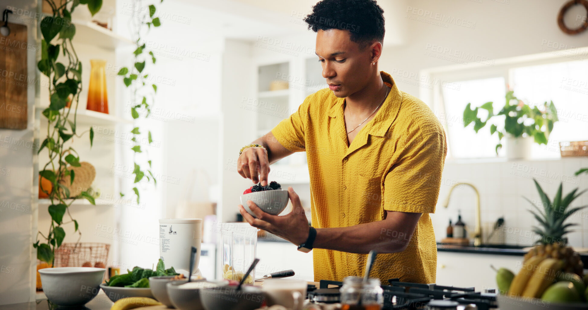 Buy stock photo Berries, bowl and food with man in kitchen of home for hobby, meal prep or nutrition. Cooking, fruit and recipe with person at apartment in morning for breakfast, diet or health as culinary chef