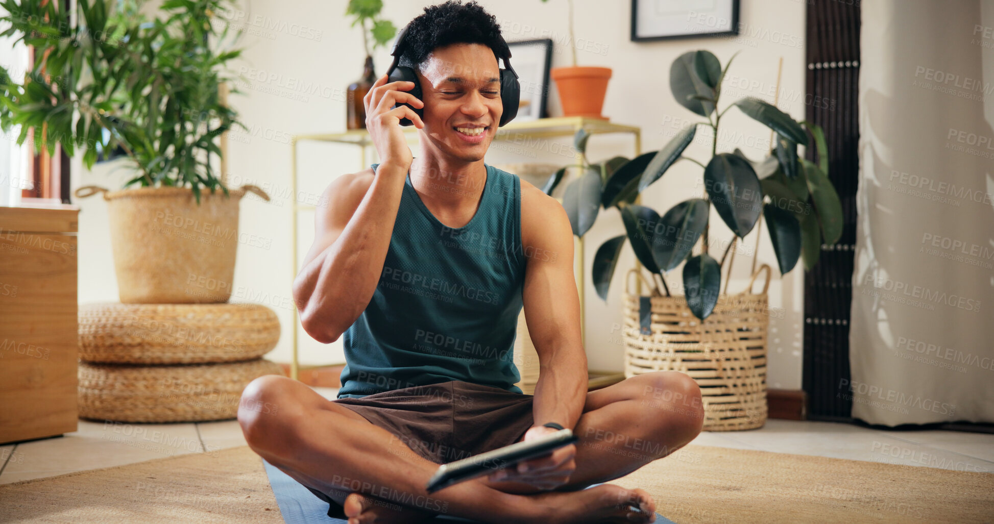 Buy stock photo Home, man and tablet with headphones for exercise, fitness podcast and application for audio track. House, male person and break with technology for social media, workout playlist or music with smile