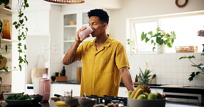 Buy stock photo Man, drinking and smoothie in kitchen for detox, healthy diet and meal replacement for wellness. Nutritionist, enjoy and protein shake in home for gut health, vitamin boost and supplement with fruit