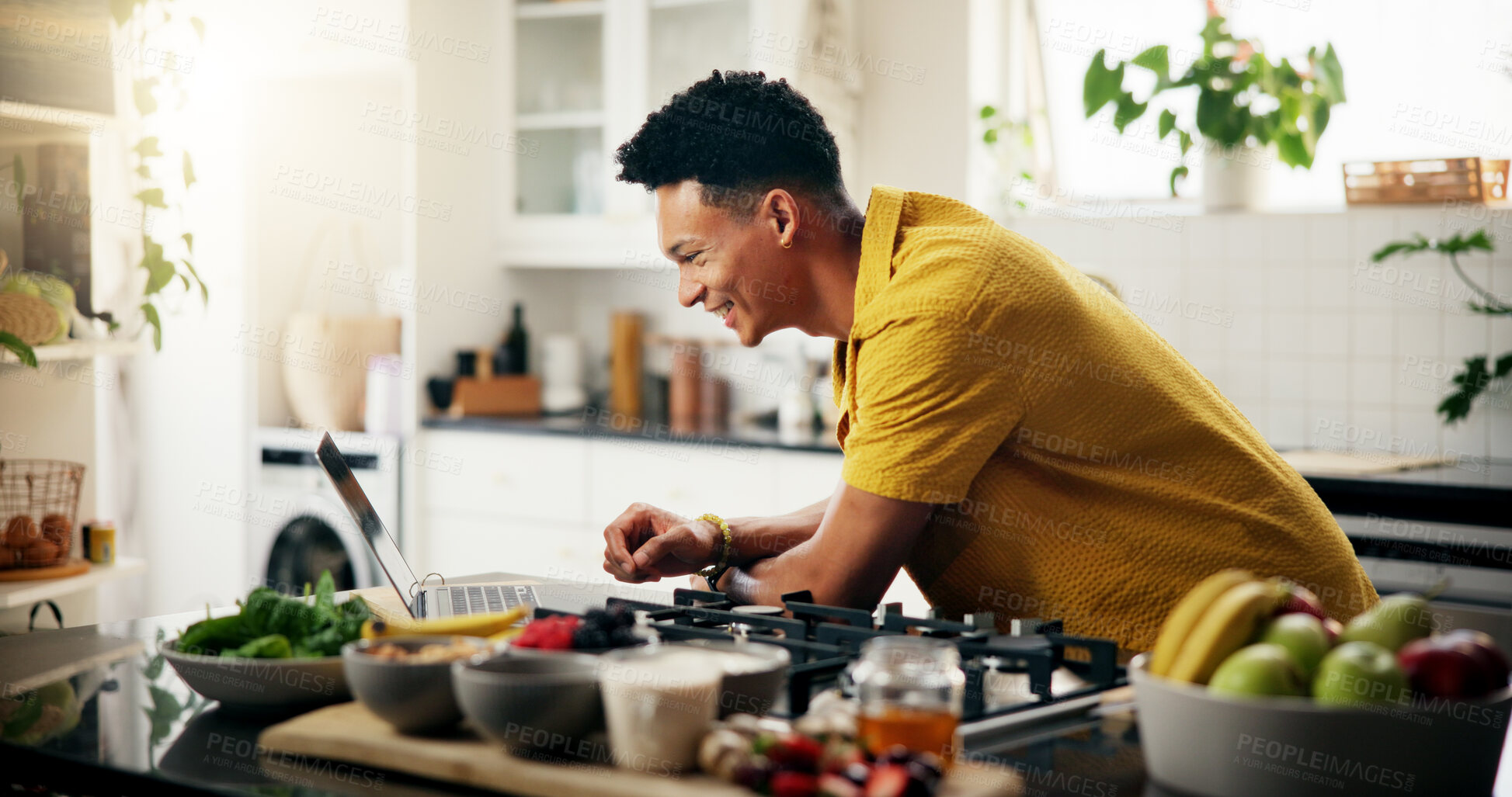 Buy stock photo Cooking, laptop and smile with man in kitchen of home for hobby, meal prep or nutrition. Ingredients, online recipe and passion with happy person in apartment for diet, health or supper as chef