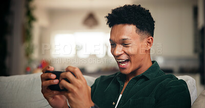 Buy stock photo Gaming, phone and relax with man on sofa for esports streaming, cyber sport league and smile. Happiness, gamer app and subscription platform with person in living room of home for online tournament