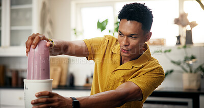 Buy stock photo Blender, wellness and man in kitchen in home for liquid diet with breakfast, nutrition or health. Beverage, detox and male person with fruit smoothie for vitamins, snack or protein shake in apartment