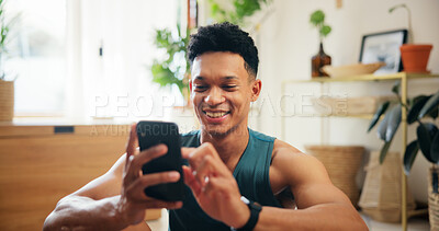 Buy stock photo Home, man and smile with smartphone for fitness, virtual exercise and scroll on website application. House, male person and break with mobile for social media, workout tips and happy with technology
