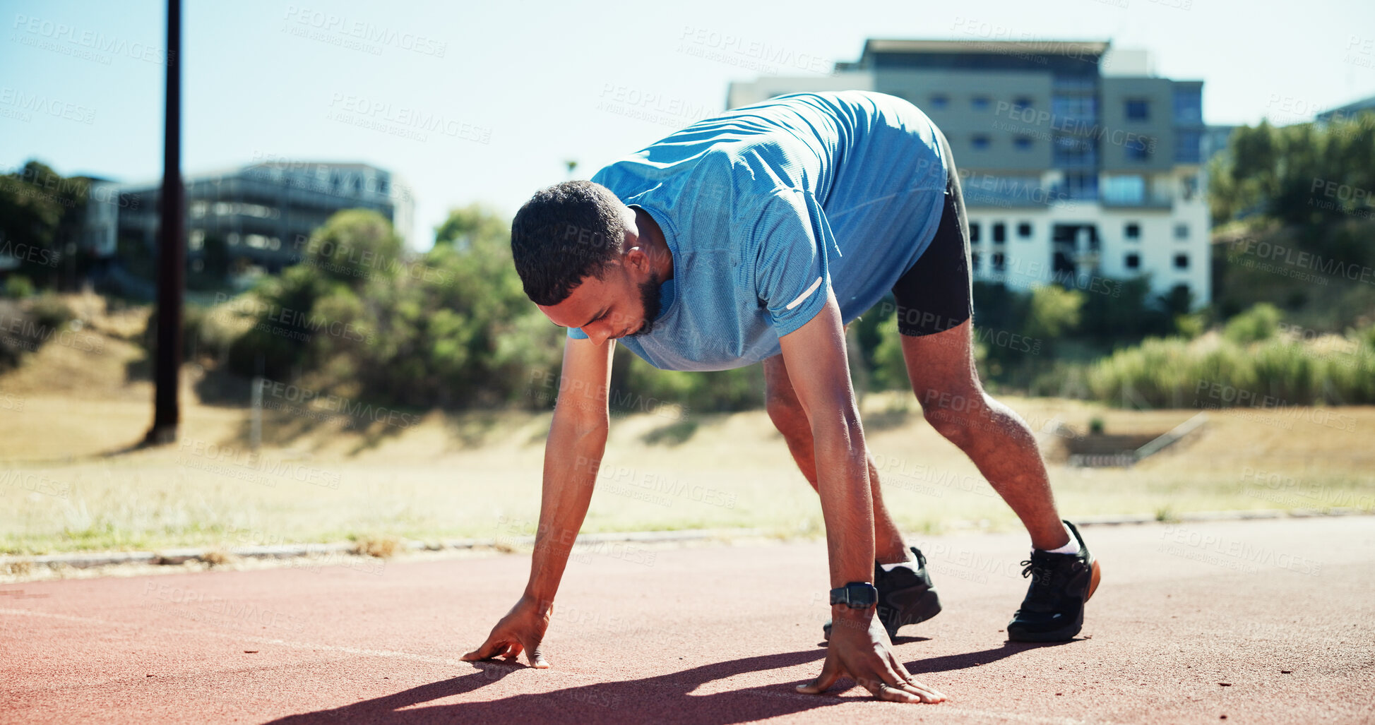 Buy stock photo Start, running and athlete or man on race track for fitness, training and cardio performance. Health, marathon and sports runner with person and outdoor stadium for competition, ready and workout