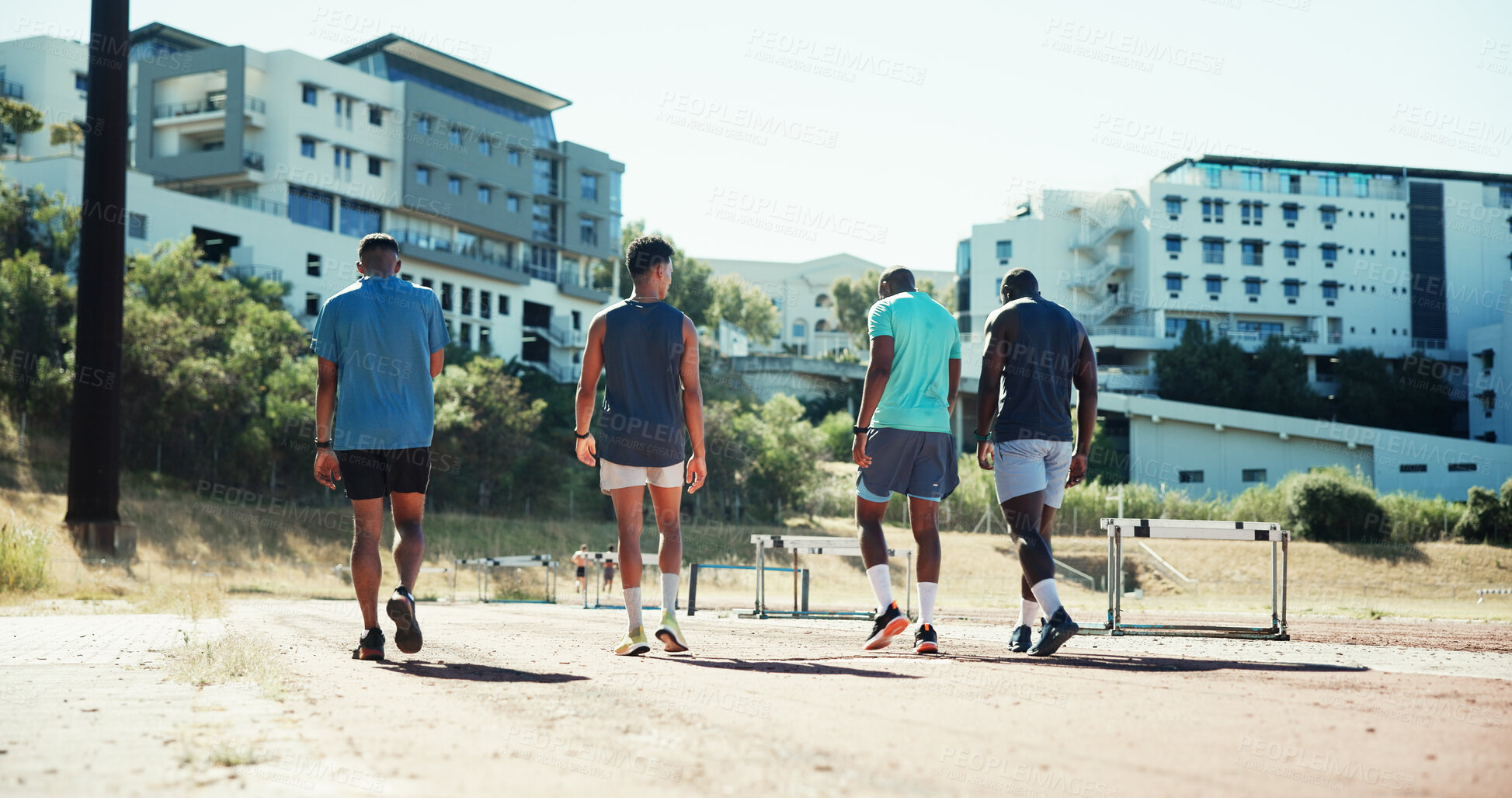 Buy stock photo Men, track and group with hurdles, training and back with equipment, runner and exercise in summer. Team, people and athlete with workout, fitness and outdoor with support for sports competition