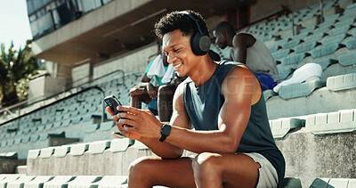 Buy stock photo Athlete, headphones and phone with man in stadium for running performance, fitness stats and online training plan. Smile, workout metrics and exercise schedule with person for competition results