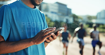 Buy stock photo Outdoor, man and hands with smartphone for exercise, online communication and scroll on application. Stadium, male person and athlete with mobile for typing message, social media or break for fitness