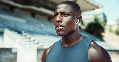 Buy stock photo Runner, earphones and music with black man in stadium for streaming, fitness podcast and workout playlist. Training, audio and athlete competition with person outdoor for radio, track and practice