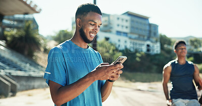 Buy stock photo Stadium, man and smile with smartphone for fitness, online communication and chat on application. Outdoor, male person and athlete with mobile for typing message, social media and break for exercise