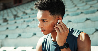 Buy stock photo Man, athlete and earphones at stadium with music, break and listening with track for fitness in summer. Person, runner and streaming with sound, audio and rest for exercise, workout and training
