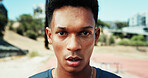 Portrait, man or runner breathing in stadium of outdoor fitness training, cardio workout or sports exercise. Race track, confident or face of male athlete on break for recovery in running practice