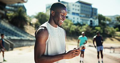 Buy stock photo Outdoor, man and message with mobile for fitness, online communication and chat on application. Stadium, male person and laughing with smartphone for typing text, social media and break for exercise