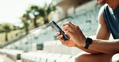 Buy stock photo Athlete, hands and phone with man in stadium for running performance, fitness stats and online training plan. Closeup, workout metrics and exercise schedule with person for competition results