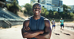 Runner, man and happy with arms crossed at stadium for sprint competition, fitness workout and race practice. Athlete, portrait and ready for running track outdoor with exercise, confidence and pride