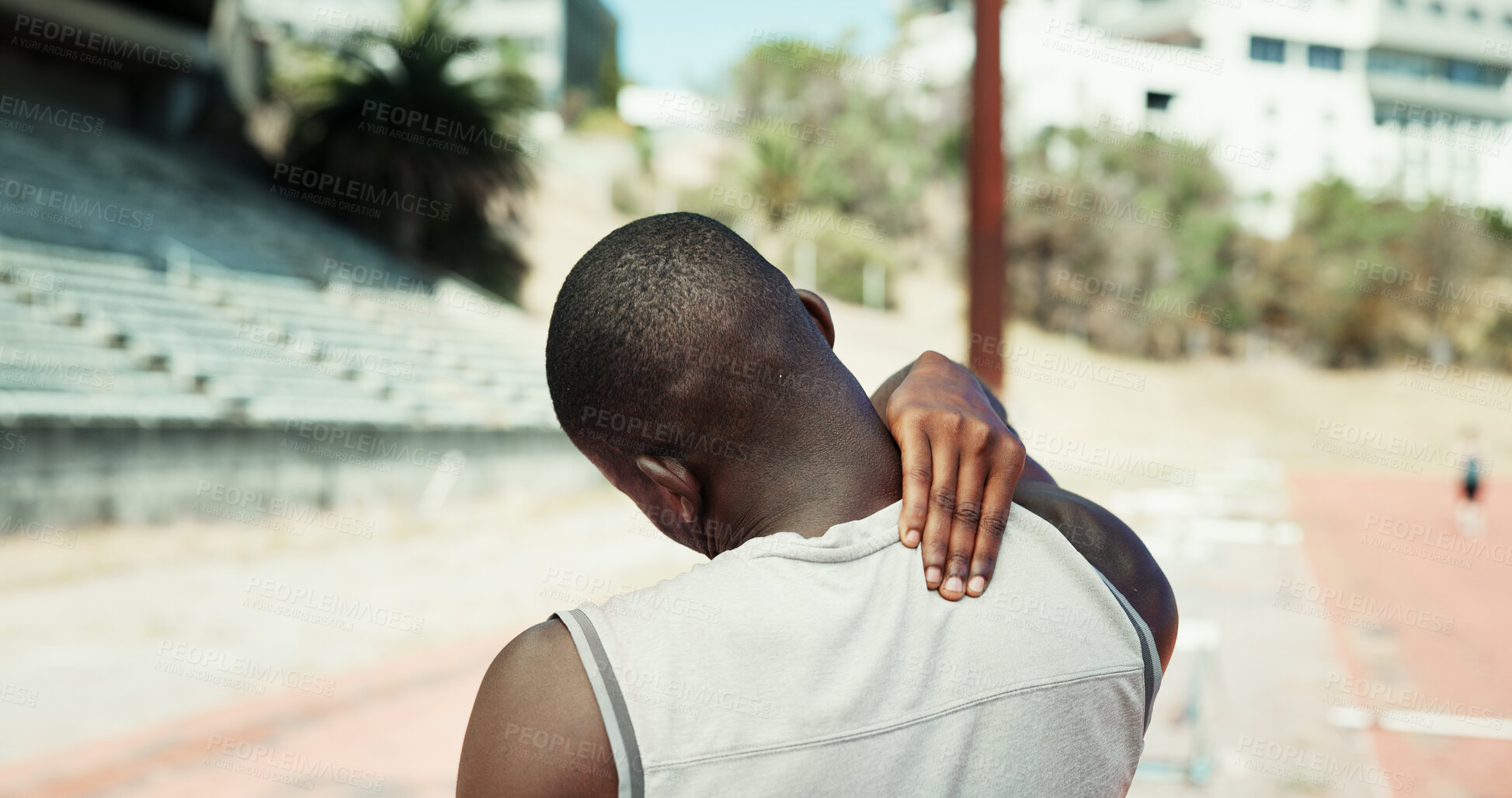 Buy stock photo Black man, stadium and pain in back with fitness, muscle sprain or tension in ligament. Athlete, runner and outdoor for sport with exercise mistake, joint injury and massage for relief in Nigeria
