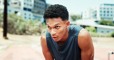 Buy stock photo Athlete, man and tired with breathing at stadium for running fatigue, race competition and burnout. Fitness workout, runner or sweating outdoor for marathon recovery, endurance challenge or exhausted