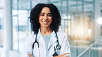 Doctor, woman and smile with arms crossed in portrait, hallway and pride for healthcare services at clinic. Person, medical professional and happy with confidence, career and hospital in Costa Rica
