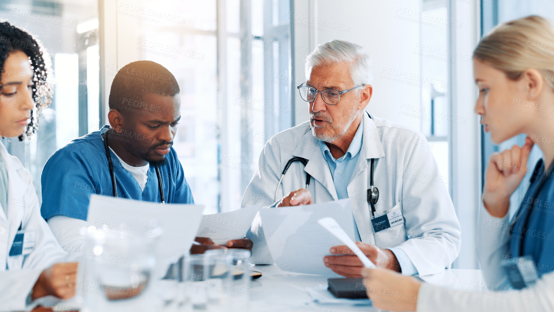 Buy stock photo Man, doctors and meeting with paperwork at hospital, review and planning with report for virus. People, medical staff and team with feedback, documents and talk for solution in boardroom at clinic