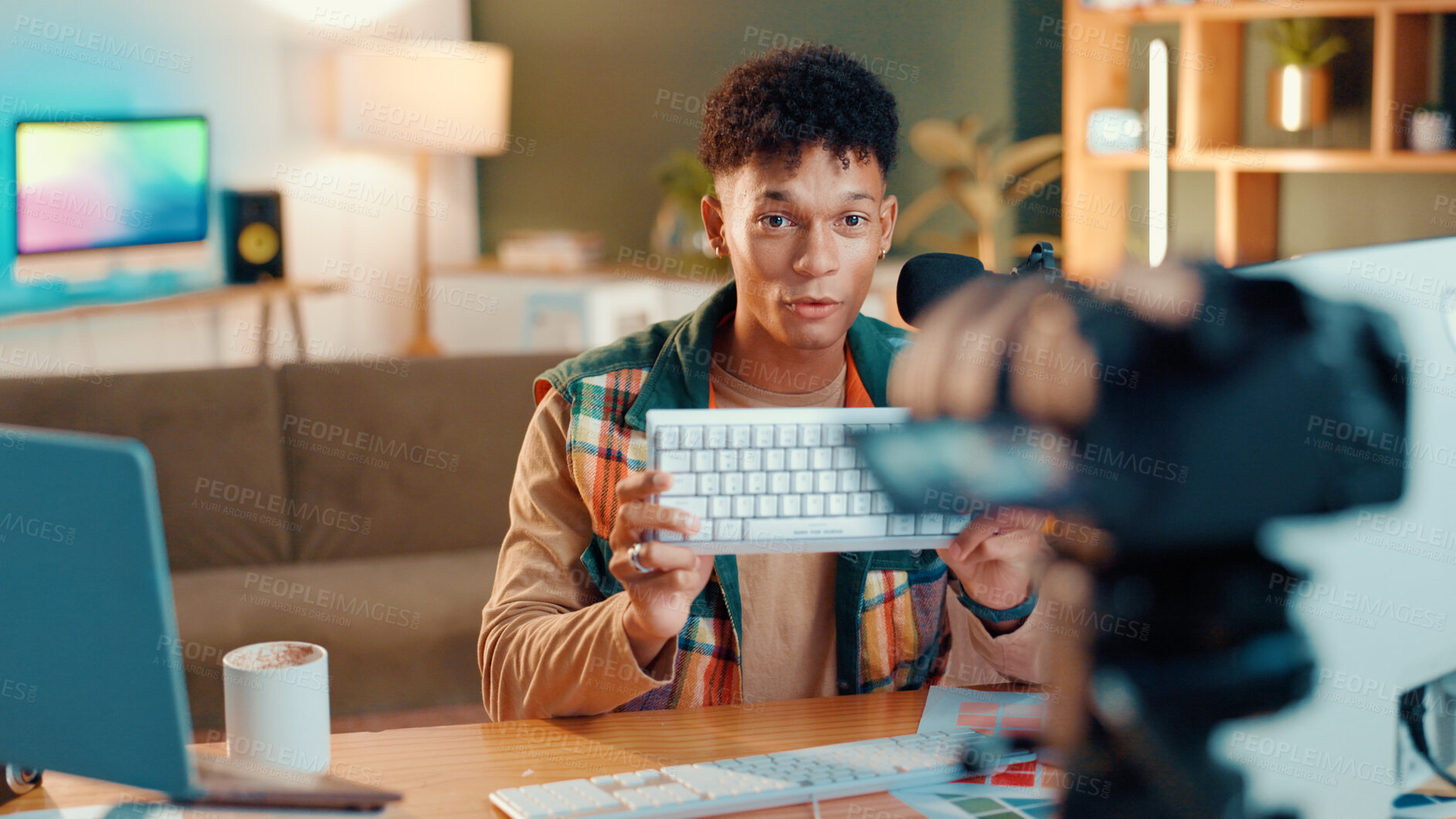 Buy stock photo Man, keyboard and recording with video camera for online streaming, gamer tips or tutorial at home. Male person, influencer or videographer with technology for vlog, gaming advice or review at house