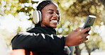 Outdoor, athlete and woman with smartphone, headphones and tracking progress of exercise on app and smile. Happy, browsing and black person with mobile for social media, online and listening to music