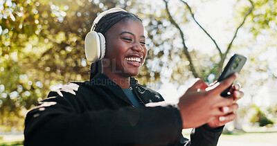 Buy stock photo Park, athlete and woman with smartphone, headphones and tracking progress of exercise on app and smile. Outdoor, browsing and black person with mobile for social media, online and listening to music