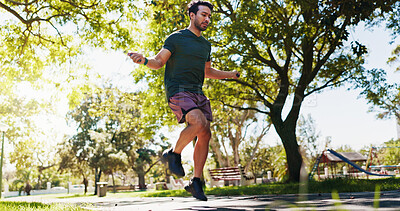 Buy stock photo Energy, jump rope and health with man in park for cardio workout, wellness and fitness. Challenge, lose weight and skipping movement with person outdoor for exercise, sports training and athlete