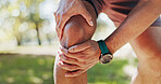Knee, injury and person with joint pain, outdoor and ligament tear in morning, accident or fracture. Nature, legs and athlete with swelling of damaged tissue, inflammation or hurt with muscle tension