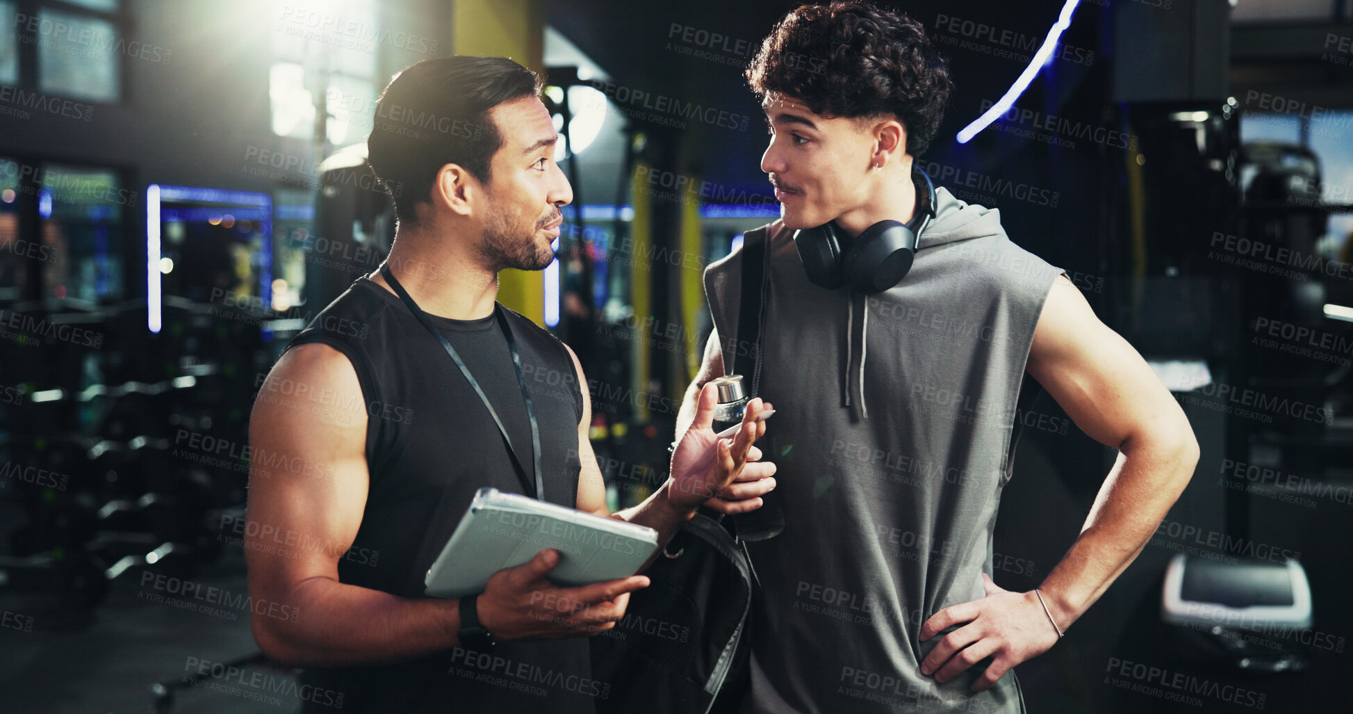 Buy stock photo Men, personal trainer and tablet with discussion at gym for advice, sign up or smile for exercise tips. People, coach and touchscreen with application for training, workout or talk at fitness center