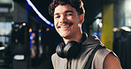 Man, portrait and headphones at gym with smile, confident and ready for routine at exercise center. Person, happy and bodybuilder with pride for workout, training and fitness at club in Portugal