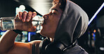 Drinking water, fitness and man in gym, thirsty and minerals with training, tired and workout. Healthy person, liquid or bottle in wellness center, nutrition and fatigue with electrolytes or refresh