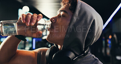Buy stock photo Drinking water, fitness and man in gym, thirsty and minerals with training, tired and workout. Healthy person, liquid or bottle in wellness center, nutrition and fatigue with electrolytes or refresh