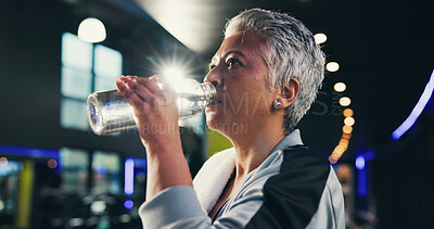 Buy stock photo Drinking water, exercise and woman in gym, thirsty and healthy with training, tired and fitness. Mature person, liquid or bottle in wellness center, nutrition and workout with electrolytes or fatigue