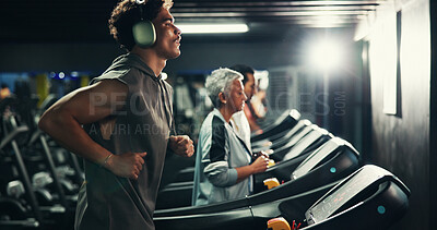 Buy stock photo Workout, man and running on treadmill with headphones at night for speed training, endurance challenge and playlist. Fitness, evening exercise and music for calorie burning and cardio routine at gym