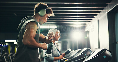 Buy stock photo Man, treadmill and check time at gym with exercise, headphones and review stats for speed with training. Person, running and machine with smart watch for progress, music and workout at fitness club